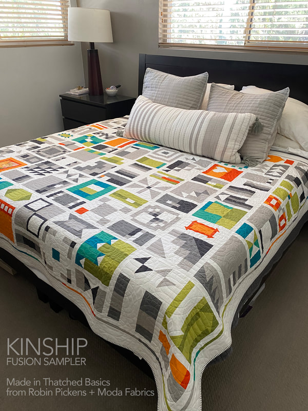 Kinship quilt in Thatched on the bed