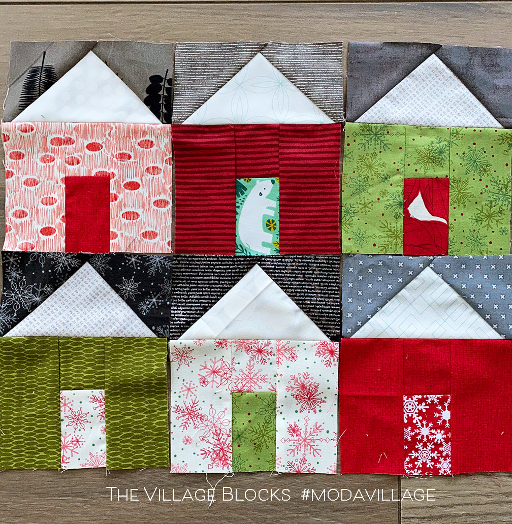 The Village quilt in Christmas fabrics with snowy roofs